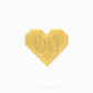 Gold heart ornament with intricate design on a white background