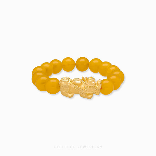 Close-up of 999 Pure Gold Yellow Agate Pixiu Bracelet with yellow agate beads and gold Pixiu charm on display.