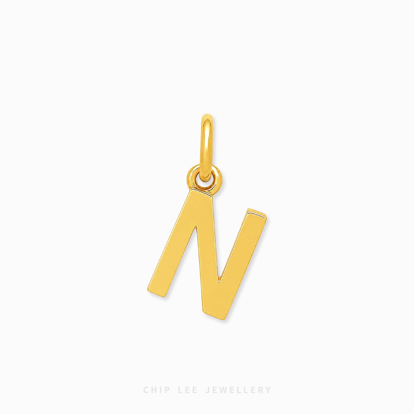 A polished gold initial pendant charm shaped like the letter 'N', shown on a clean white background with a subtle shadow.