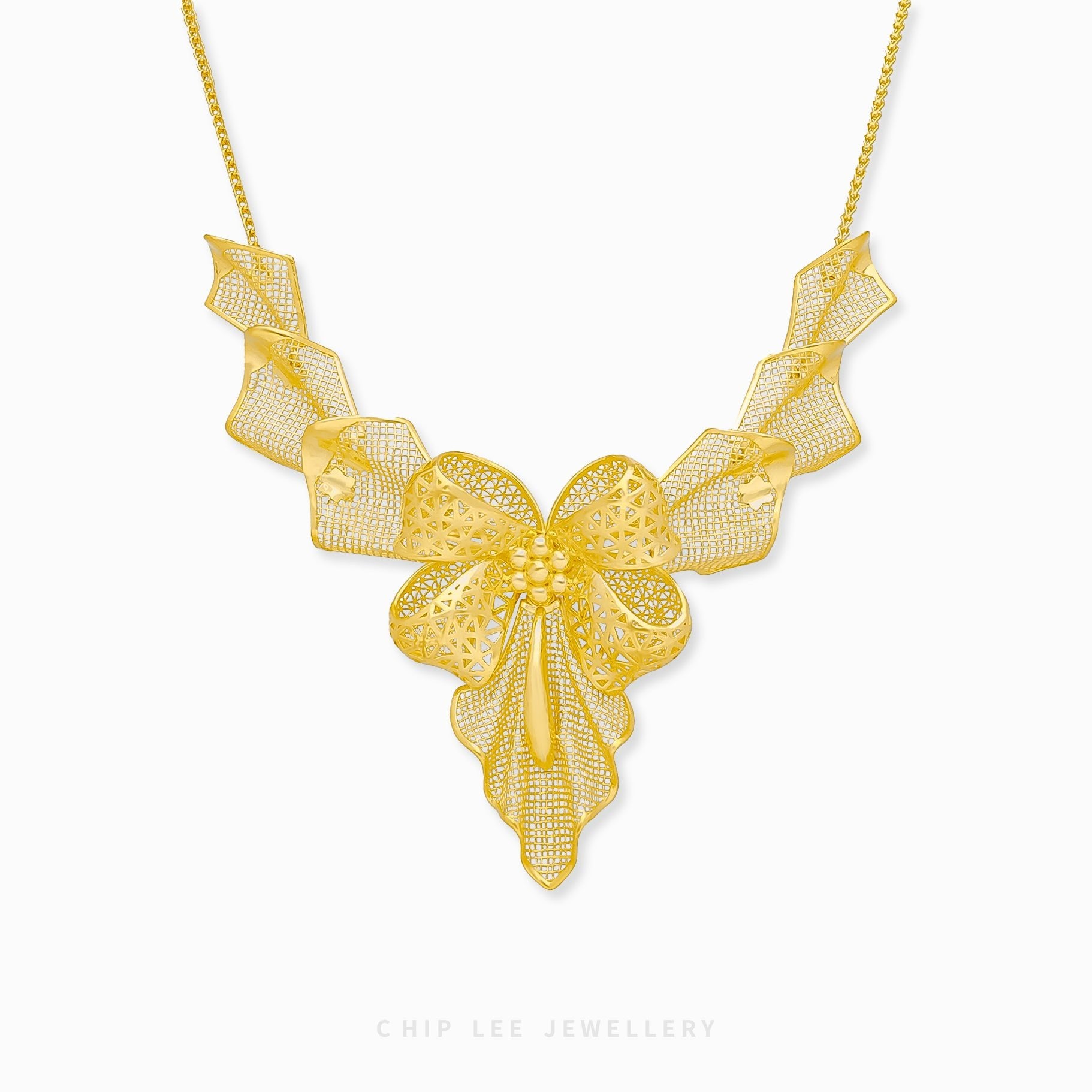 999 Pure Gold Statement Bow Necklace with bold bow pendant in solid gold, combining playful charm and timeless elegance for all occasions.