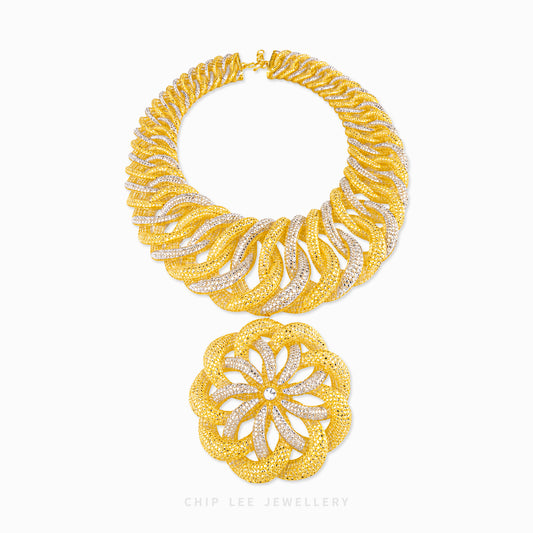 A gold and silver pavé necklace set by Chip Lee Jewellery, featuring a wide collar-style necklace and a matching round pendant, displayed on a clean white background.