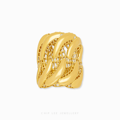 Gold ring with intricate design on a white background