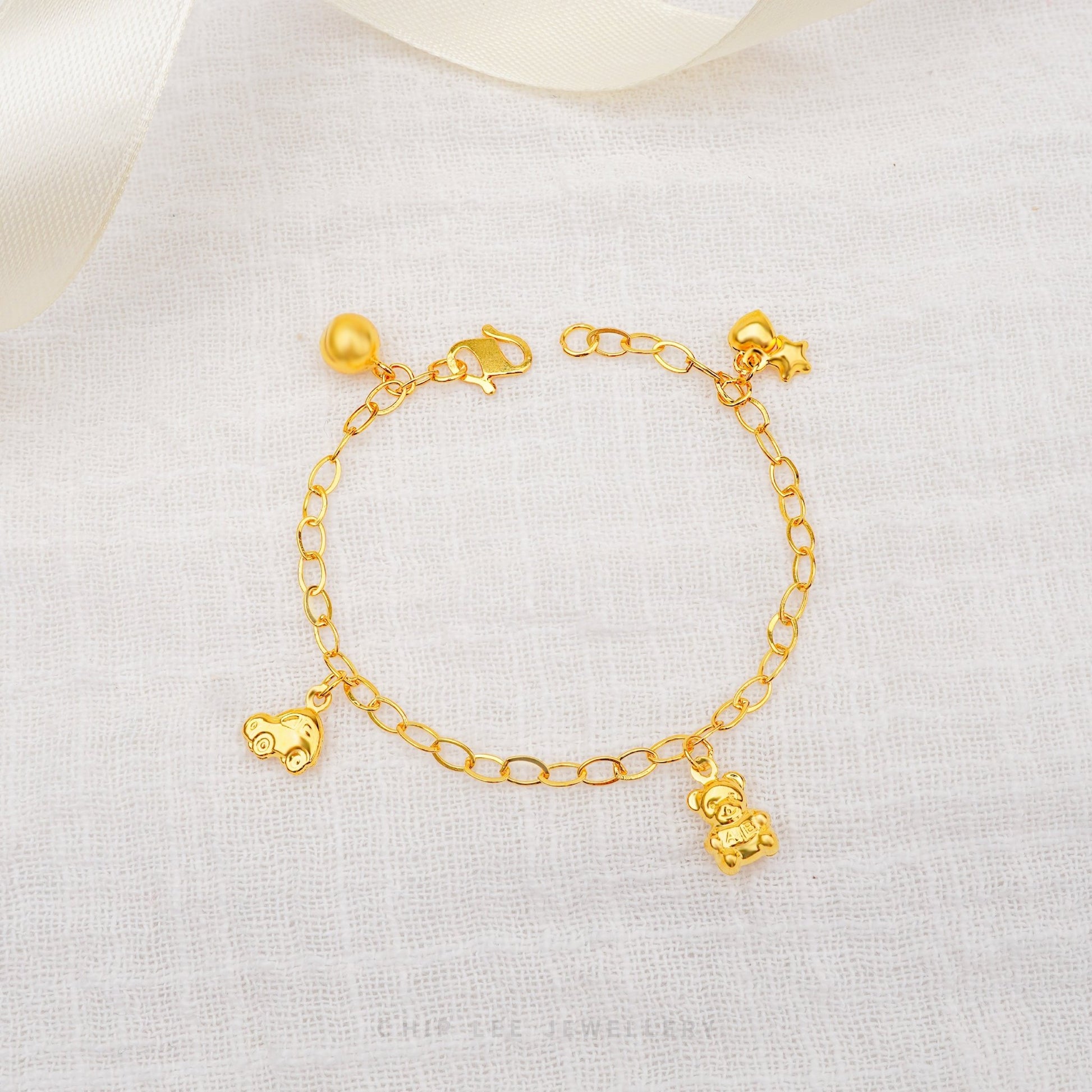 Bear, Car, Heart, and Star Charms Baby Bracelet by Chip Lee Jewellery, 916 gold, featuring playful charms, symbolizing joy and protection for newborns.