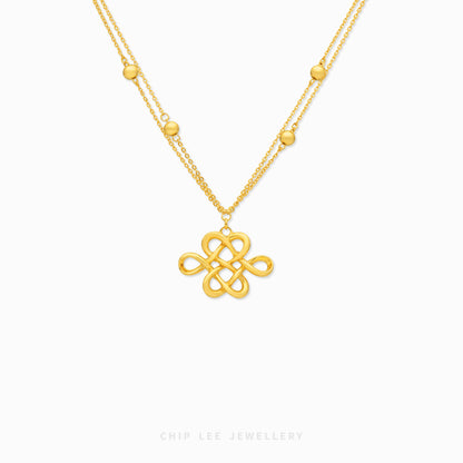 A gold necklace featuring a central interlocking knot pendant and a delicate chain with small gold beads, shown on a clean white background with the brand name 'CHIP LEE JEWELLERY' at the bottom.