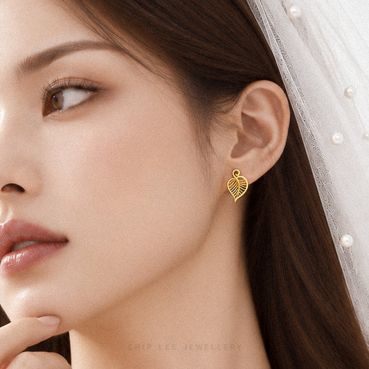A close-up of a woman wearing a delicate gold leaf-shaped stud earring, with a white pearl-trimmed veil visible on her head. The brand name 'CHIP LEE JEWELLERY' is subtly printed at the bottom.