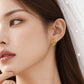 A close-up of a woman wearing a delicate gold leaf-shaped stud earring, with a white pearl-trimmed veil visible on her head. The brand name 'CHIP LEE JEWELLERY' is subtly printed at the bottom.