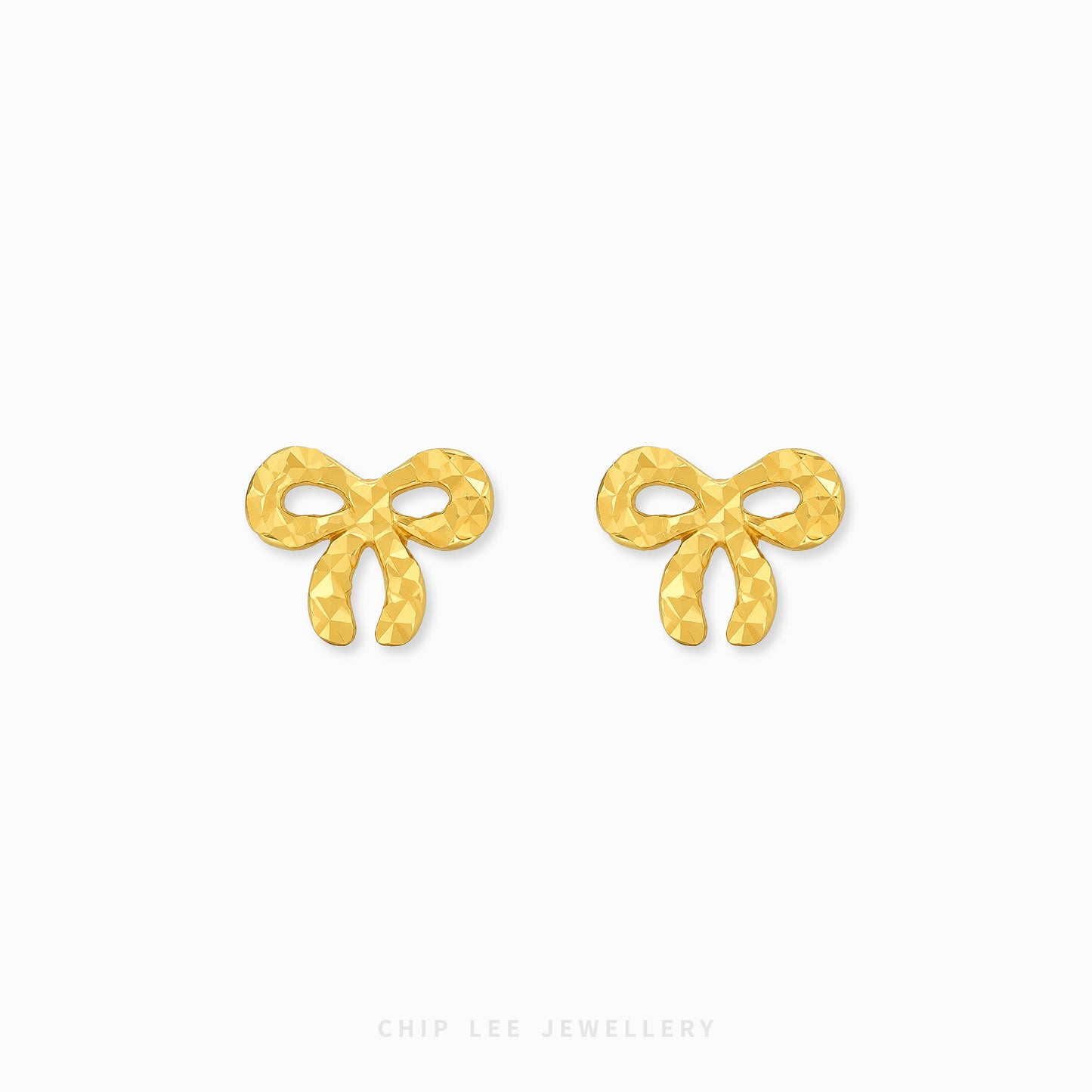 A pair of gold bow-shaped stud earrings with a textured, faceted surface, displayed on a clean white background with the brand name 'CHIP LEE JEWELLERY' printed at the bottom.