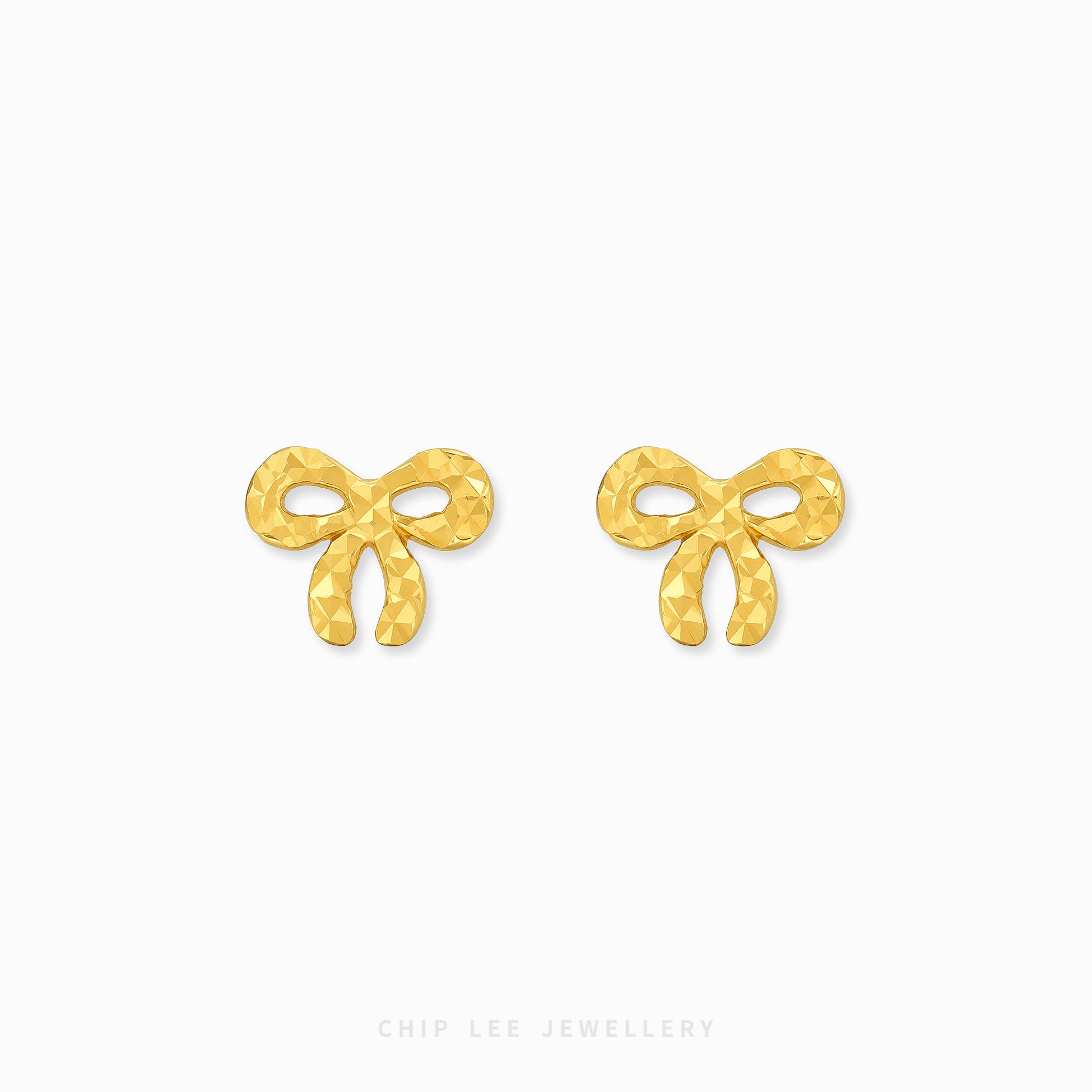 A pair of gold bow-shaped stud earrings with a textured, faceted surface, displayed on a clean white background with the brand name 'CHIP LEE JEWELLERY' printed at the bottom.
