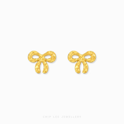 A pair of gold bow-shaped stud earrings with a textured, faceted surface, displayed on a clean white background with the brand name 'CHIP LEE JEWELLERY' printed at the bottom.