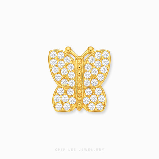 A gold butterfly-shaped charmpaved with small clear stones, centered on a light gray background with the brand name 'CHIP LEE JEWELLERY' faintly visible at the bottom.