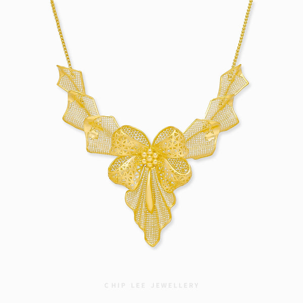 999 Pure Gold Statement Bow Necklace with bold bow pendant in solid gold, combining playful charm and timeless elegance for all occasions.