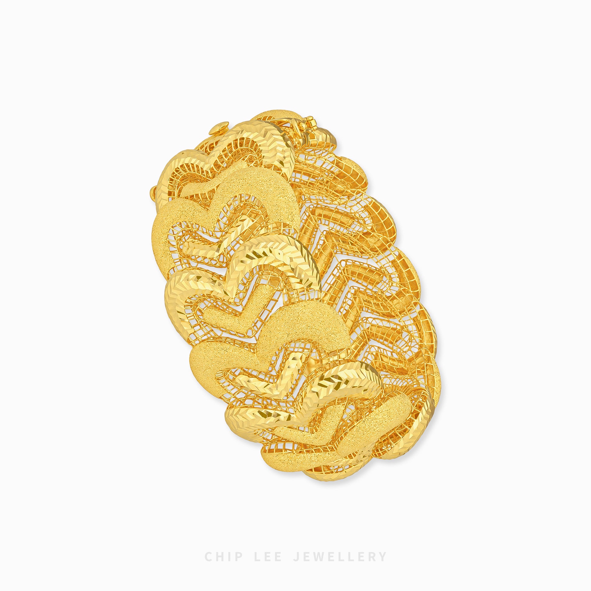 A chunky gold bangle bracelet with a textured, layered chevron pattern and small pavé-set clear stones, shown on a plain white background with a Chip Lee Jewellery watermark at the bottom.