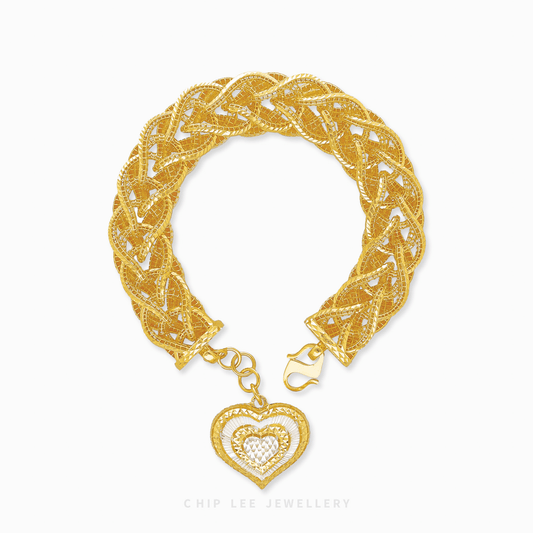 916 gold bracelet for women with intricate braided design and dangling two-tone polished heart pendant. Certified and hallmarked.