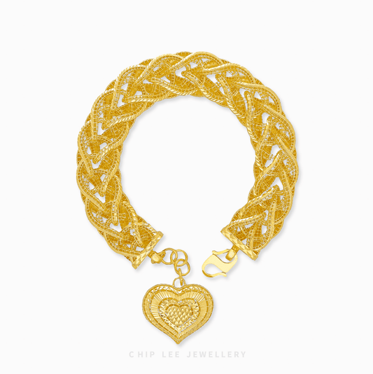 916 gold bracelet for women with intricate braided design and dangling two-tone polished heart pendant. Certified and hallmarked.
