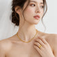 A woman wearing a delicate gold chain necklace and a matching gold heart-shaped ring, shown in a soft, bridal-style close-up. The brand name 'CHIP LEE JEWELLERS' is faintly visible at the bottom.