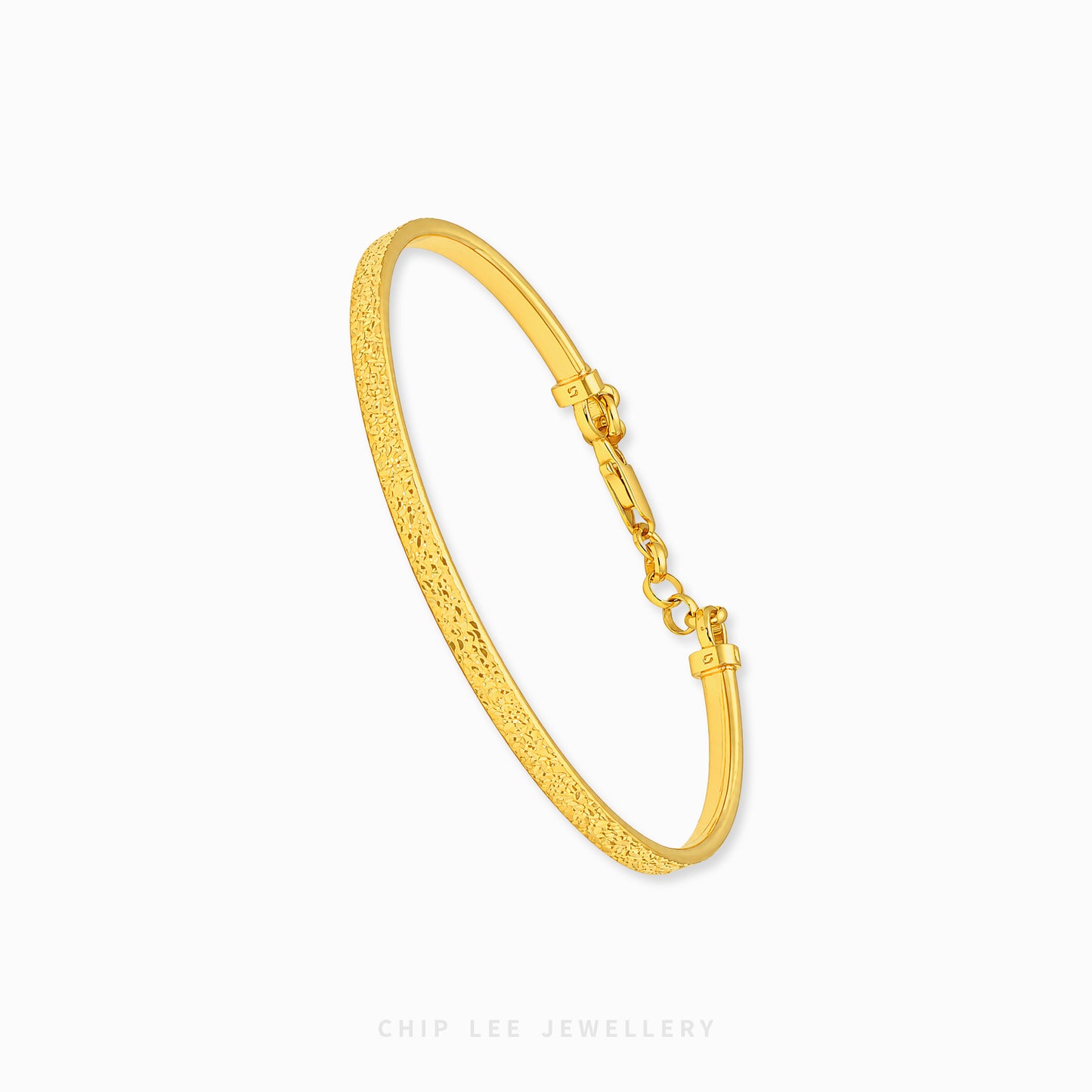 A textured yellow gold hinged bangle bracelet with a lobster clasp, shown on a clean white background with the brand name 'CHIP LEE JEWELLERY' at the bottom.