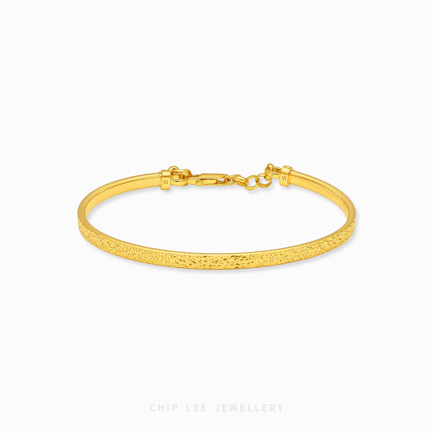 A textured yellow gold hinged bangle bracelet with a lobster clasp, shown on a clean white background with the brand name 'CHIP LEE JEWELLERY' at the bottom.