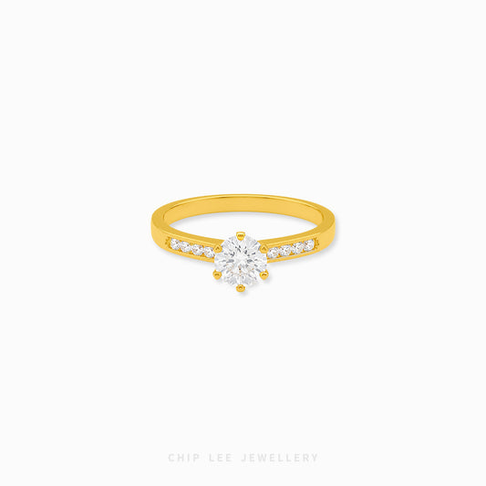Cubic Zirconia pavé solitaire ring featuring a brilliant round-cut centre stone with sparkling shoulder-set stones on a polished gold band.