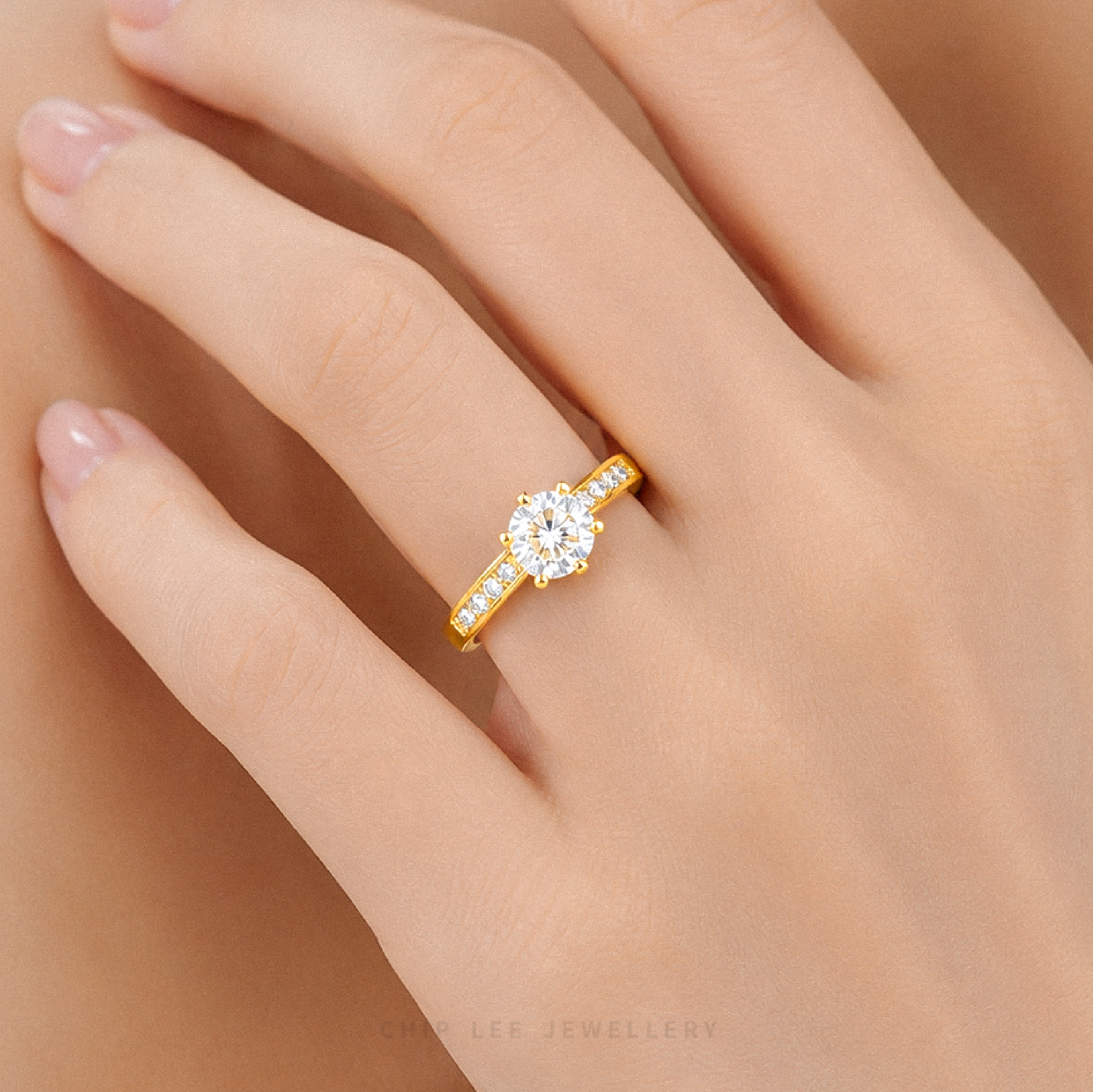Cubic Zirconia pavé solitaire ring featuring a brilliant round-cut centre stone with sparkling shoulder-set stones on a polished gold band.