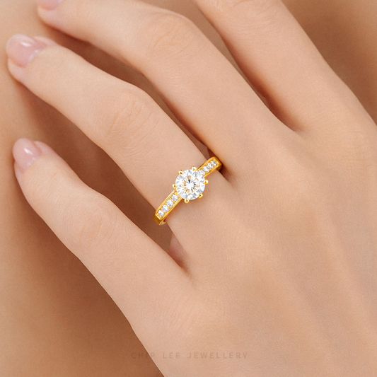Cubic Zirconia pavé solitaire ring featuring a brilliant round-cut centre stone with sparkling shoulder-set stones on a polished gold band.