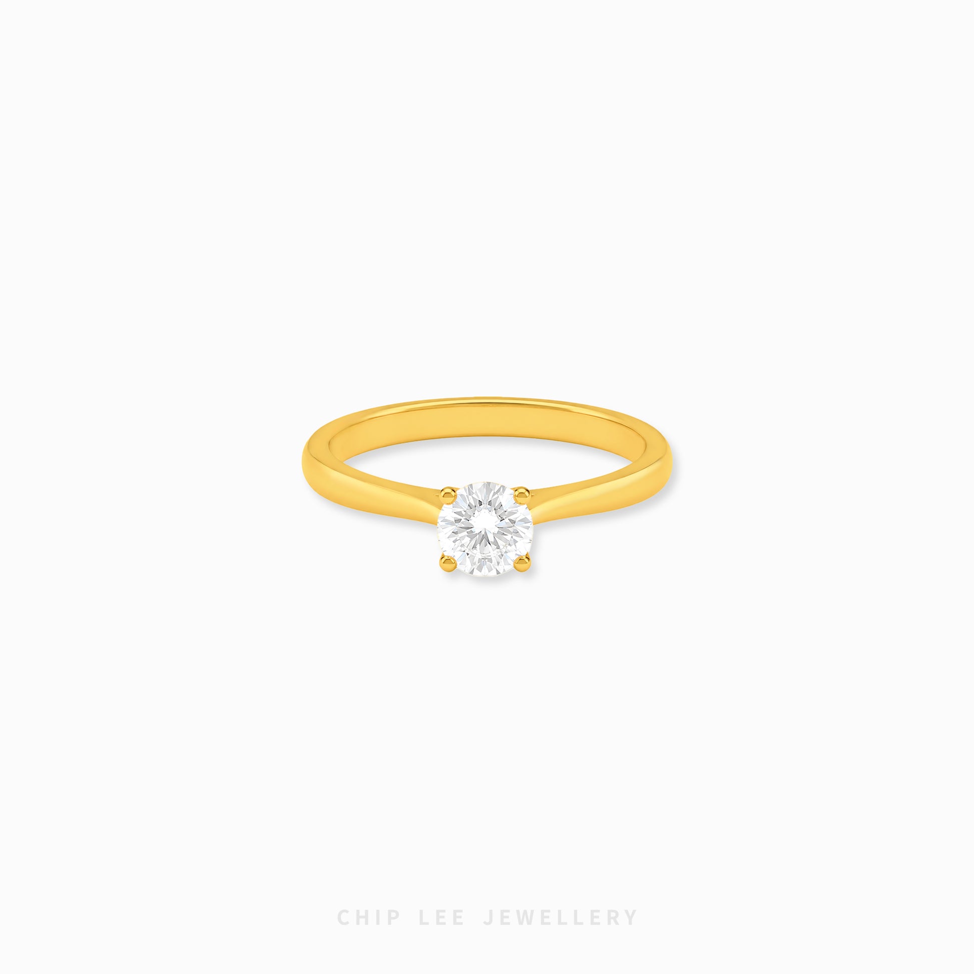 999 Gold Cubic Zirconia Solitaire Ring featuring a brilliant round-cut cubic zirconia on a polished yellow gold band.