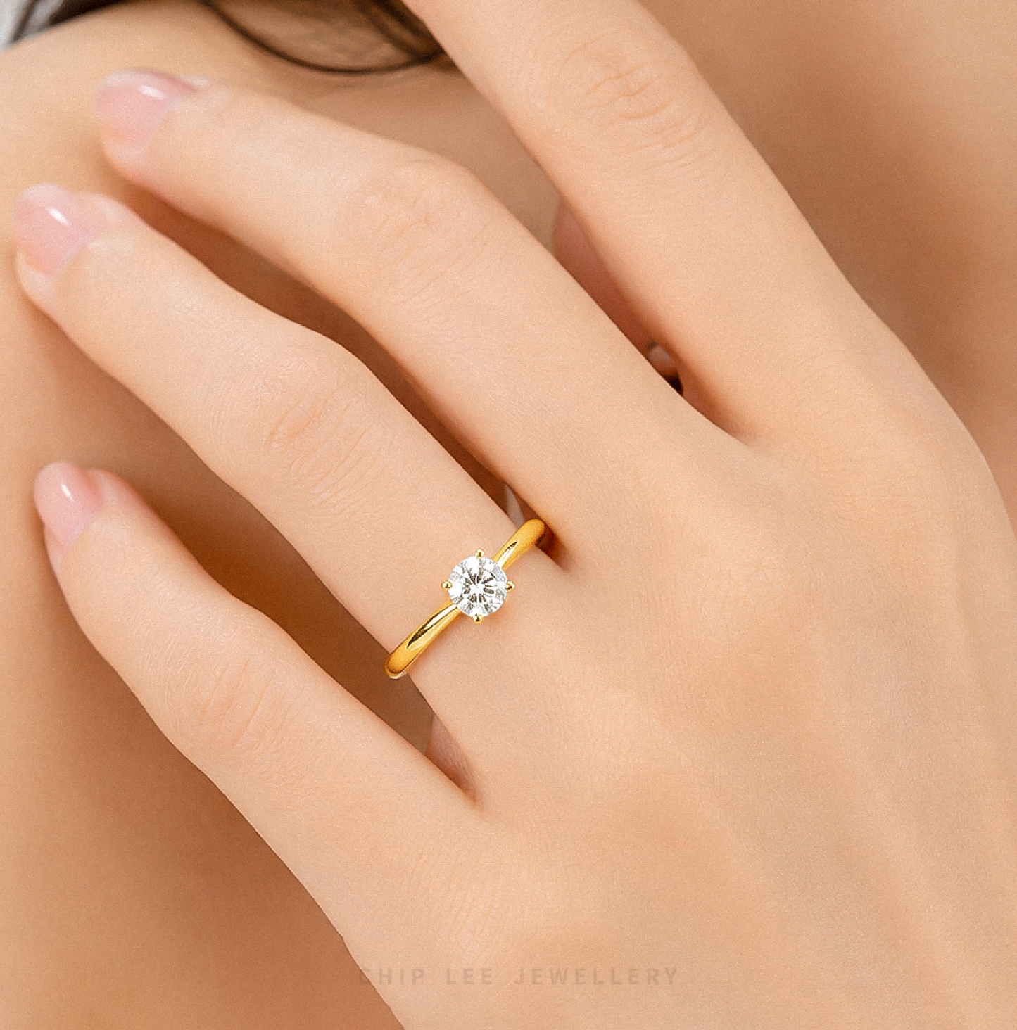 999 Gold Cubic Zirconia Solitaire Ring featuring a brilliant round-cut cubic zirconia on a polished yellow gold band.