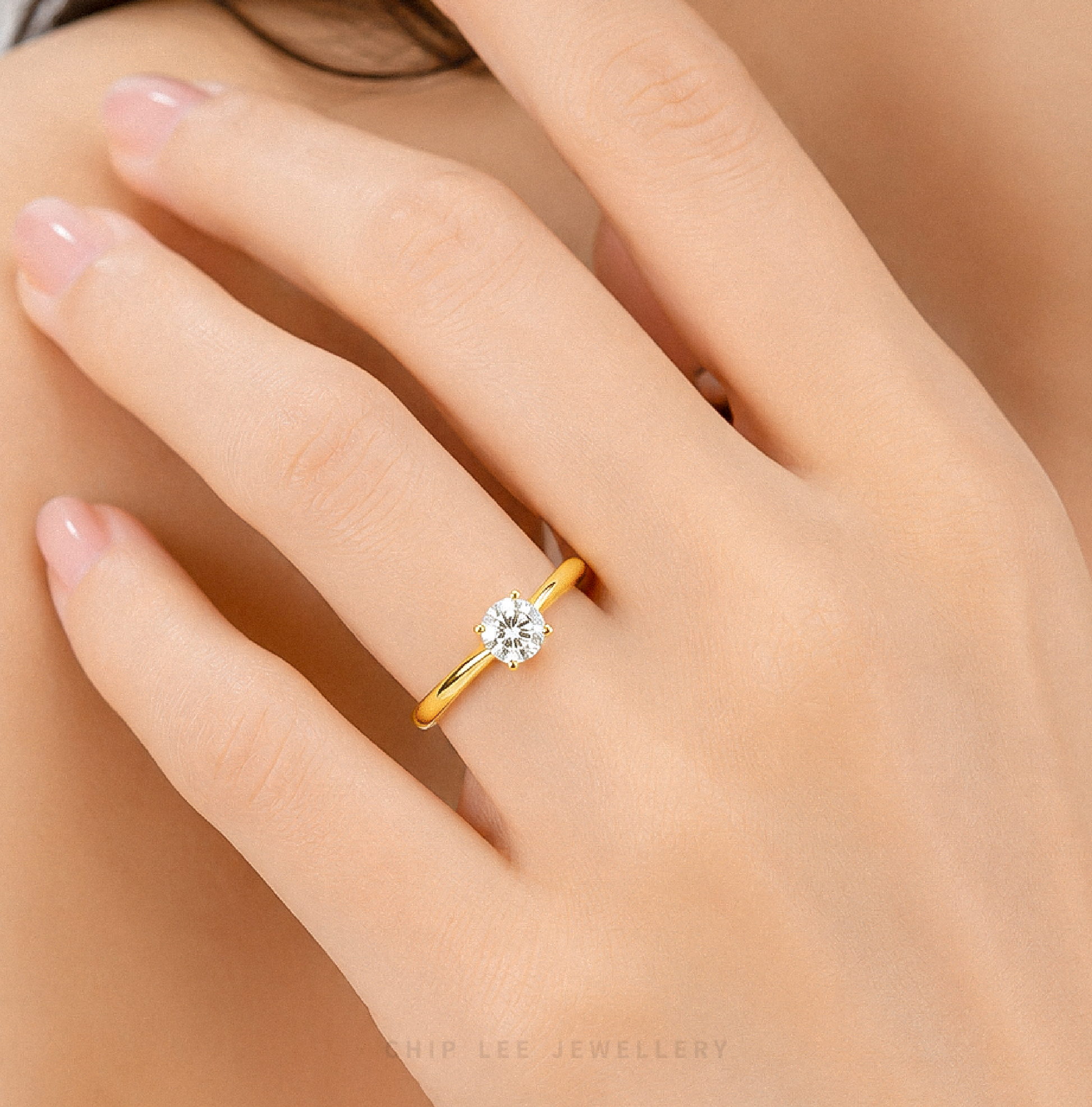 999 Gold Cubic Zirconia Solitaire Ring featuring a brilliant round-cut cubic zirconia on a polished yellow gold band.