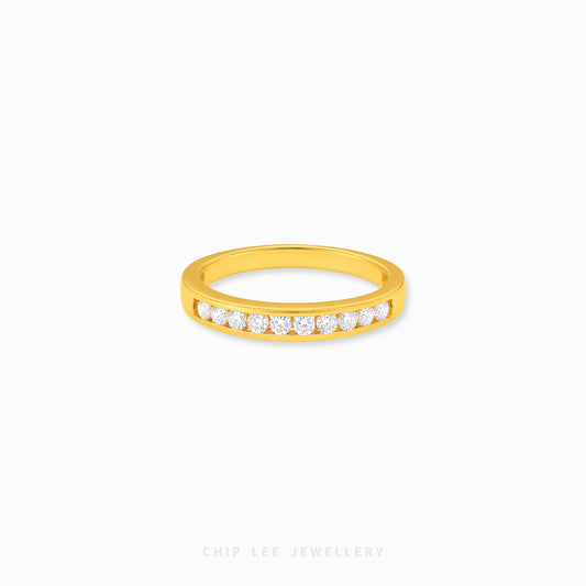 Gold half eternity ring featuring brilliant round-cut cubic zirconia stones in a polished minimalist setting.