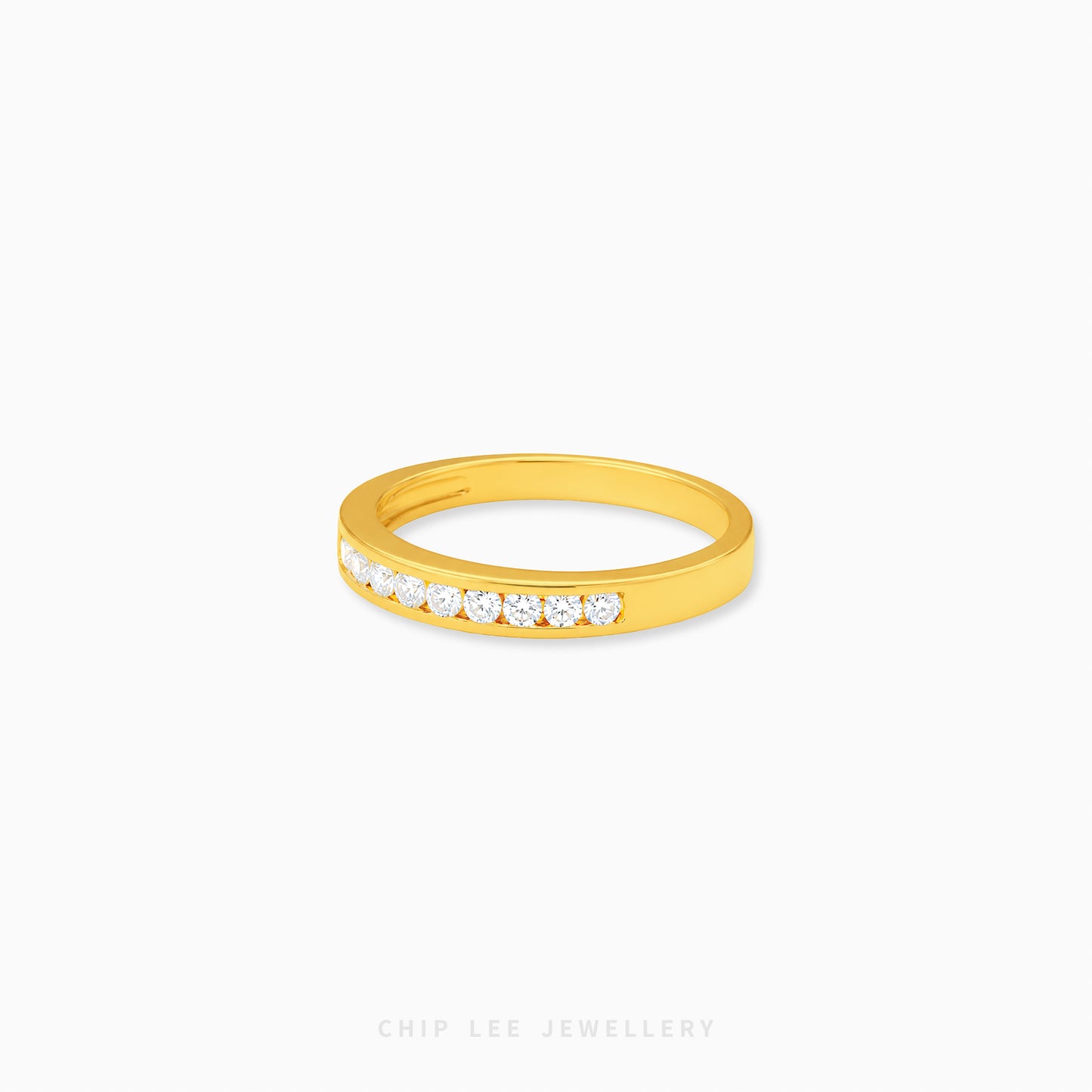 Gold half eternity ring featuring brilliant round-cut cubic zirconia stones in a polished minimalist setting.