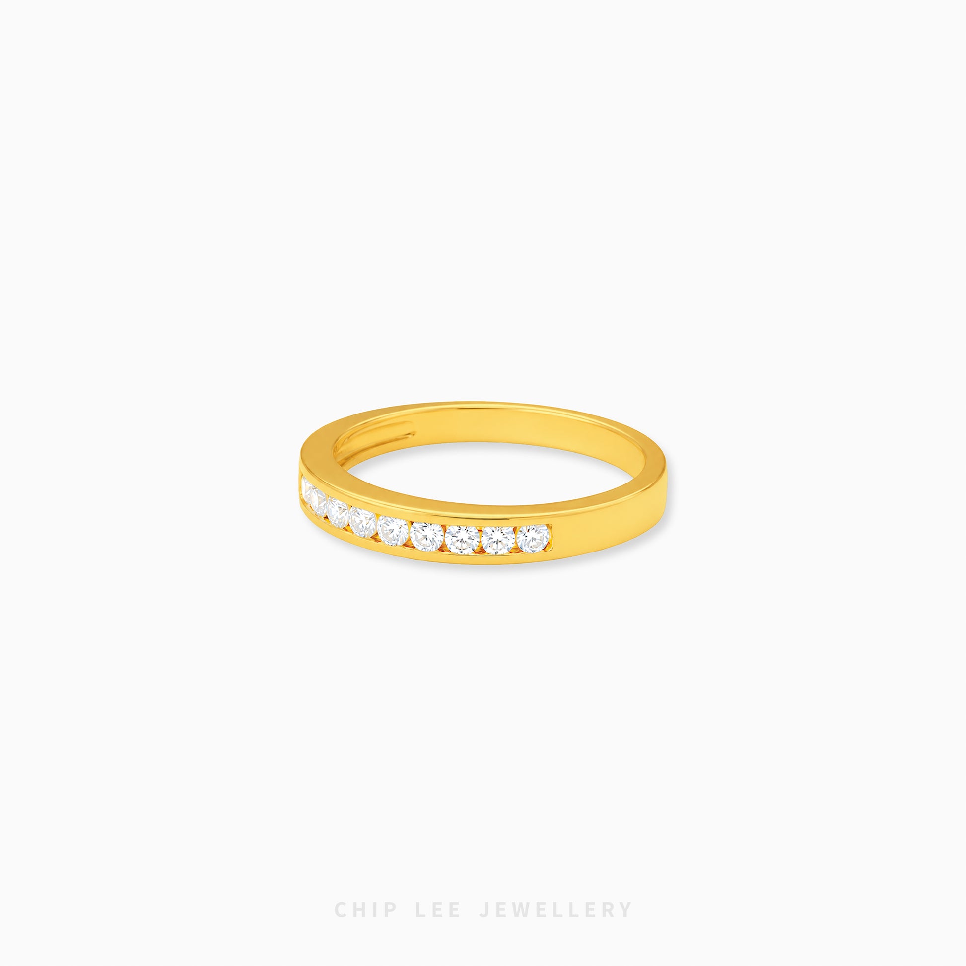 Gold half eternity ring featuring brilliant round-cut cubic zirconia stones in a polished minimalist setting.