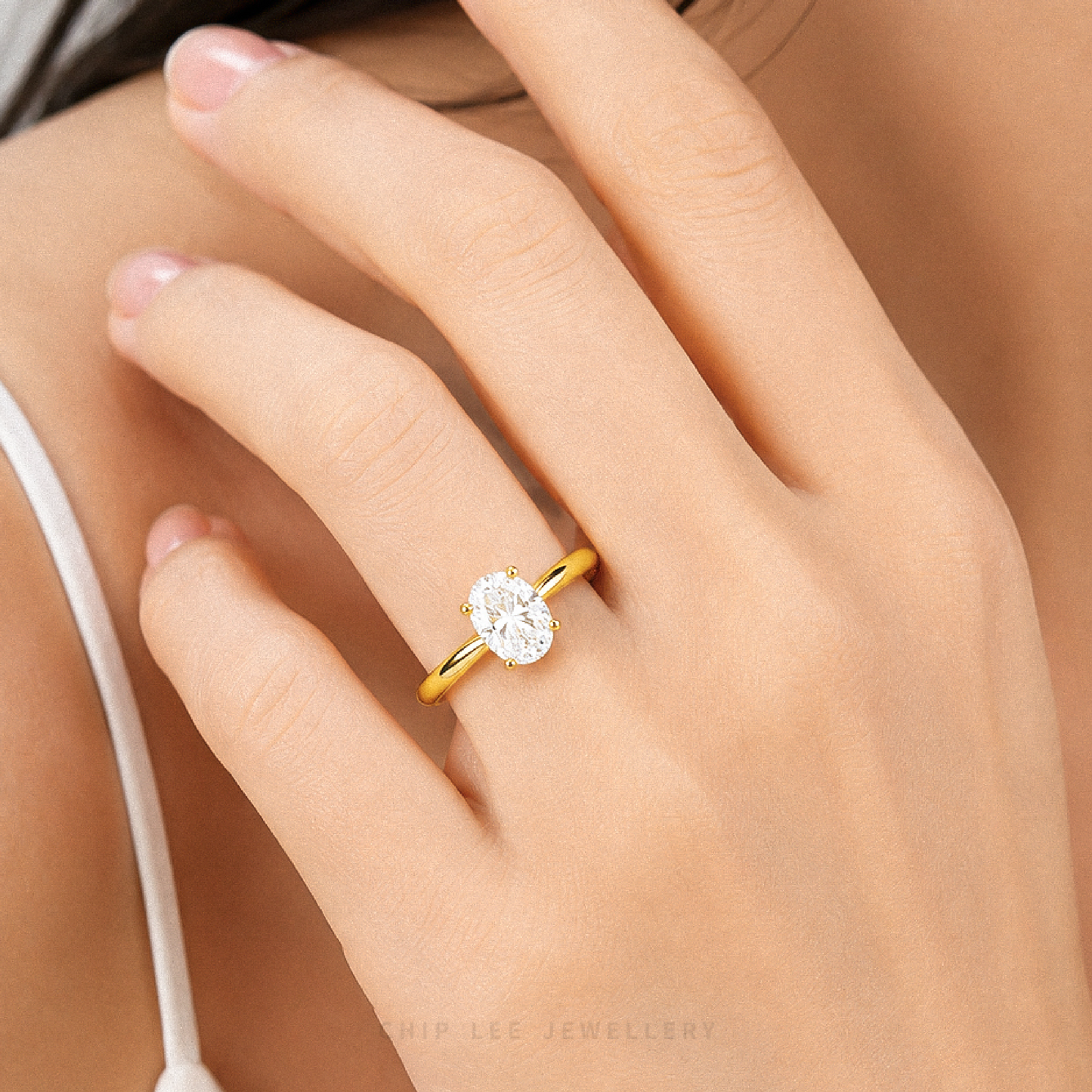 Oval Cubic Zirconia Solitaire Ring with a brilliant oval-cut stone on a polished gold band.