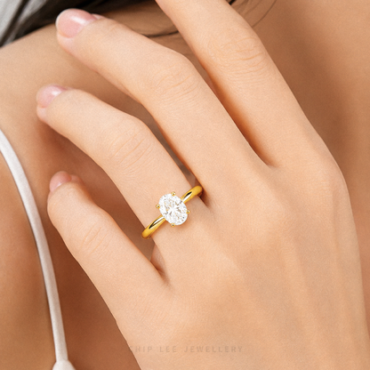 Oval Cubic Zirconia Solitaire Ring with a brilliant oval-cut stone on a polished gold band.