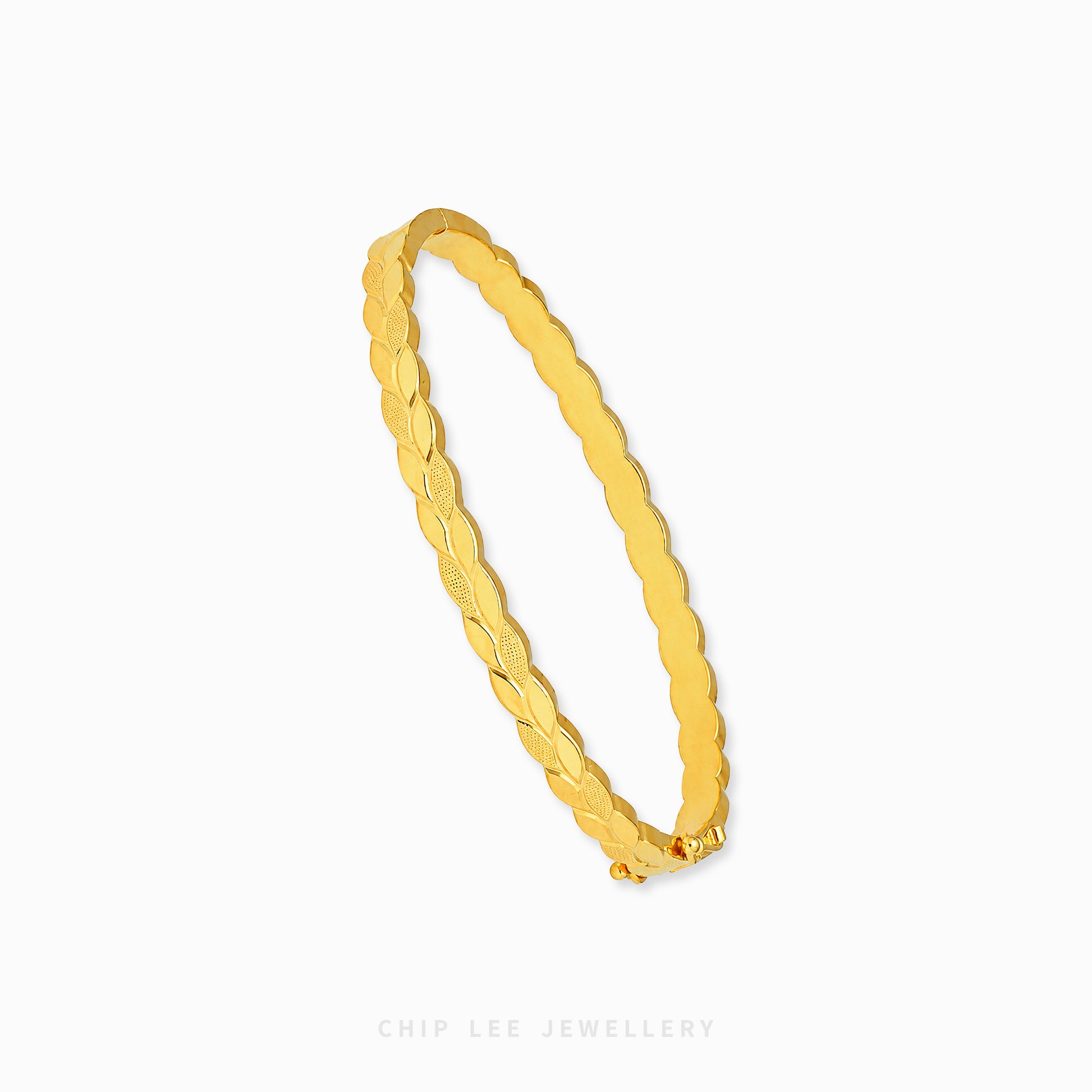 A gold bangle bracelet with a textured, ridged pattern, shown on a clean white background with a brand watermark at the bottom.