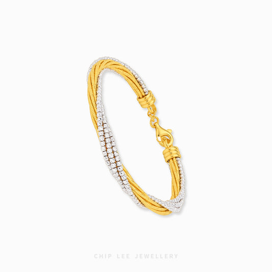 A gold and white gold multi-strand cable bracelet with pavé-set clear stones on one side and a gold lobster clasp, shown on a light gray background with Chip Lee Jewellery branding at the bottom.
