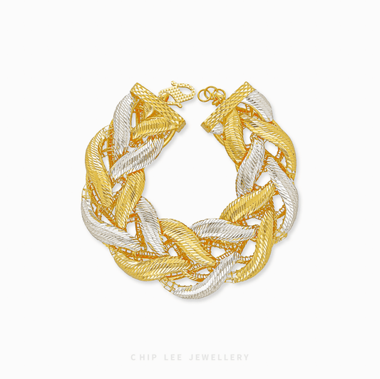 Gold and silver braided bracelet on a white background