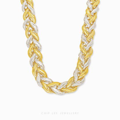 Two-tone braided necklace on a white background