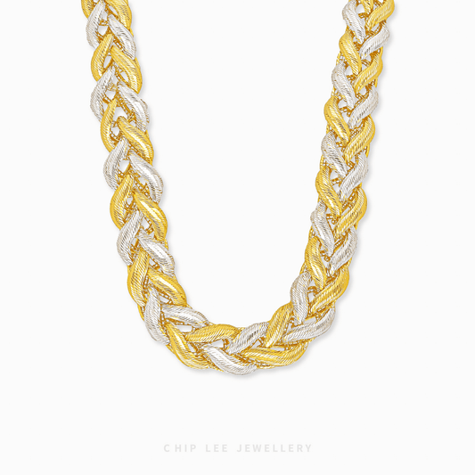 Two-tone braided necklace on a white background
