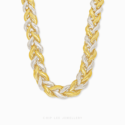 Two-tone braided necklace on a white background