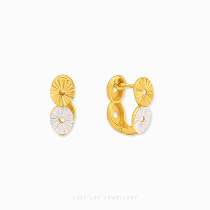 Two-tone hoop earrings with modern disc detailing and contemporary styling.