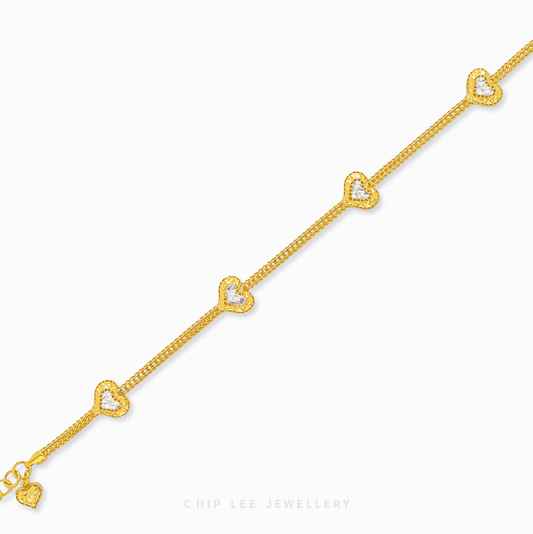 Duo Tone Heart Charm Bracelet in 916 gold. Subtle, symbolic heart design perfect for stacking or a timeless statement.