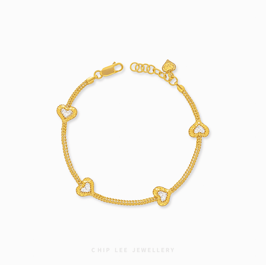 Duo Tone Heart Charm Bracelet in 916 gold. Subtle, symbolic heart design perfect for stacking or a timeless statement.