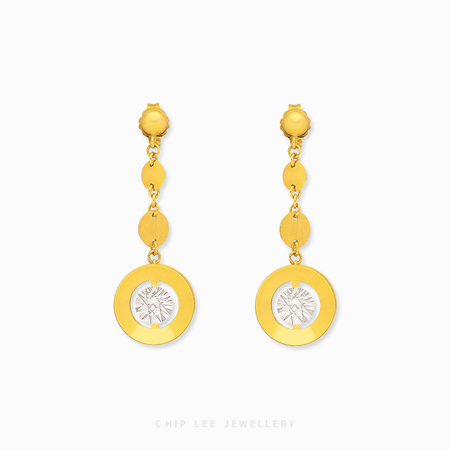 Gold earrings with circular designs on a white background