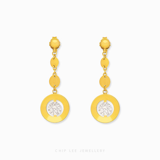 Gold earrings with circular designs on a white background