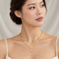 A woman wearing a gold necklace with circular disc motifs and clear rhinestone accents, photographed against a soft light beige fabric backdrop. The brand name 'CHIP LEE JEWELLERY' is faintly visible at the bottom.