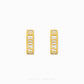 A pair of gold huggie hoop earrings with white Roman numerals, shown from both front and side angles on a light gray background with 'CHIP LEE JEWELLERY' text at the bottom.
