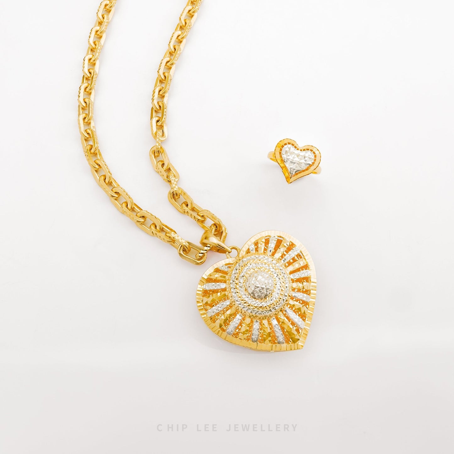 Duo Tone Sunburst Heart Pendant in yellow & white 22K gold by Chip Lee Jewellery Singapore – certified 916 gold, dynamic sunburst heart design.
