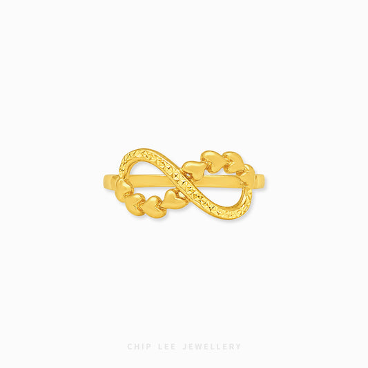 A gold infinity ring featuring a series of small heart links, displayed on a clean white background with the brand name 'CHIP LEE JEWELLERY' printed at the bottom.