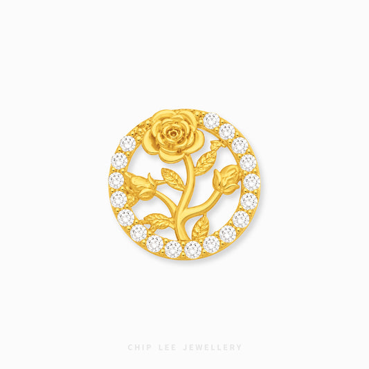 A circular gold rose charm by Chip Lee Jewellery, featuring a central gold rose and stem motif surrounded by a border of small clear pavé stones on a white background.