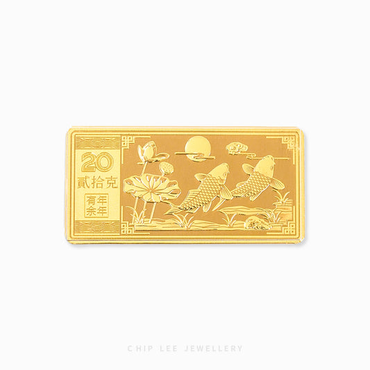 A 999 pure gold bar with an embossed design featuring fishes and flowers with Chinese characters. Hallmarked in Singapore for certified purity and authenticity.