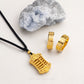Gold necklace and rings on a white background with a rock.